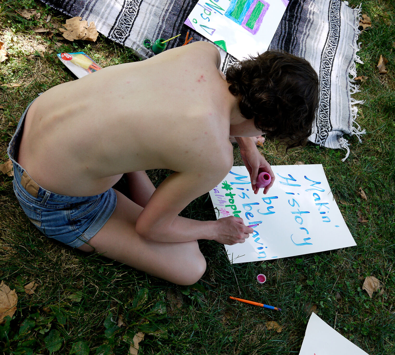 Helen Humphreys draws a sign to march